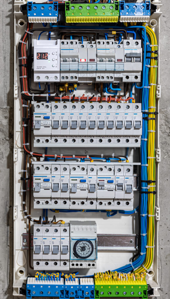 Voltage switchboard with circuit breakers, close up. Voltage switchboard with circuit breakers are in the ON and OF positions in the big electric box for electrical distribution panel, and temporary electric cables are switched.